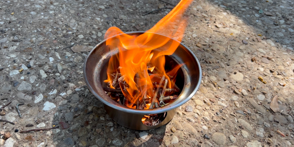 Kelly kettle fire pan with fire burning inside